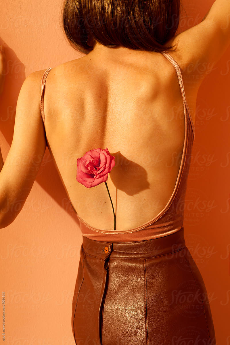 Woman With Long Leather Skirt Leaning Against A Wall